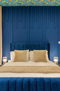 a blue bedroom with a large bed with two pillows at The Carlton Heights by The HIve WA1 in Warrington +7 photos