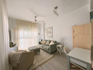 a living room with a couch and a table at Ático Dúplex con Jacuzzi en Vera Playa y parking cubierto enorme in Vera +27 photos