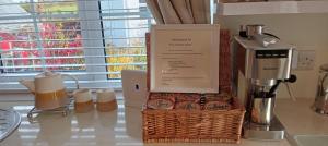 a kitchen counter with a basket of food and a blender at The Garden Suite 3 Star NITB SuperHost in Dungannon