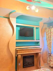 a living room with a tv and a fireplace at Presidential Apartment in Suceava