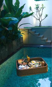 a tray of food on top of a swimming pool at Vintage 83 Tangalle in Tangalle