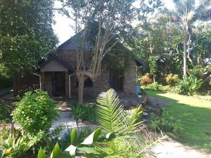 a small stone house in the middle of a garden at Big Blue Breaks in Umkomaas