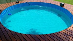 a large blue swimming pool on a wooden deck at Cabañas Ganesha in Federación