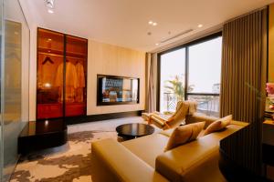 a living room with a couch and a table at X-Digital HOTEL in Bắc Ninh