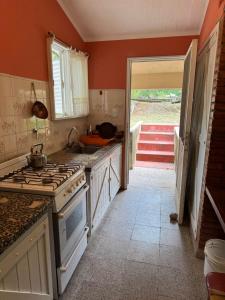 una cucina con piano cottura e una porta aperta di Casa 7 Cajones a Trapiche Altre 5 foto