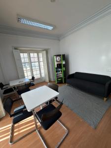 a living room with a couch and a table and chairs at Residencial Sky Lounge in Lisbon