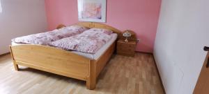 a bedroom with a wooden bed with a wooden floor at Ferienwohnung in Baunatal in Baunatal