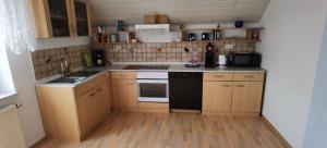 a small kitchen with a black and white stove top oven at Ferienwohnung in Baunatal in Baunatal
