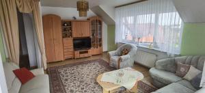 a living room with a couch and a table at Ferienwohnung in Baunatal in Baunatal