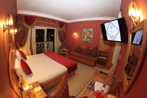 a bedroom with a bed and a television in it at Oriental Rivoli Hotel & Spa in Sharm El Sheikh