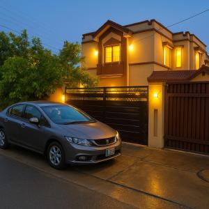 a car parked in front of a house at Haven Lodge - 4BR Luxurious Spanish Villa in Lahore in Lahore