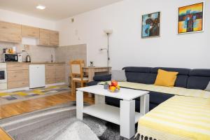 a living room with a couch and a table at AVA Apartment Istočno Sarajevo in Lukavica