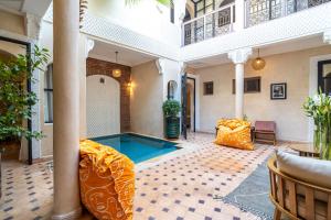 a pool in the middle of a building at Riad Beldi in Marrakesh