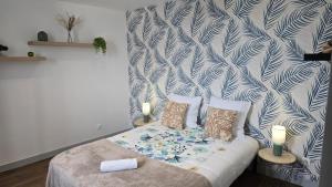 a bedroom with a bed with two candles on it at Le Comte de Saxe - Calme à Blois centre in Blois