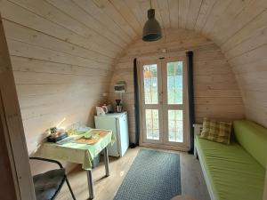 a small room with a table and a refrigerator at Guesthouse Kohvikann in Palmse