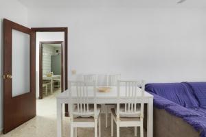 a dining room with a white table and chairs at Casa En El Centro De Barbate in Barbate +11 photos