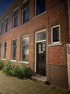 a brick building with a door on the side of it at 't Zusje in Enschede