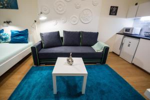 a living room with a couch and a table at Concept Apartments in Budapest