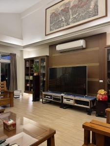 a living room with a large flat screen tv at 台東358民宿 in Taitung City +56 photos
