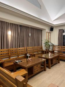 a conference room with wooden tables and benches at 台東358民宿 in Taitung City