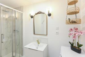 a bathroom with a shower and a sink and a mirror at Twilight Star Spa - Sauna & Private Cinema - Free Parking in Amiens