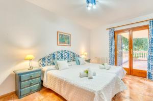 a bedroom with a large bed and a window at Ideal Property Mallorca - Can Besso in Alcanada +33 photos