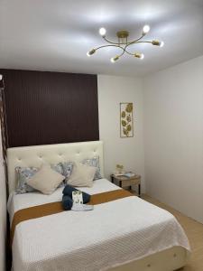 a bedroom with a large bed with a hat on it at As Thetic Transient in San Pablo