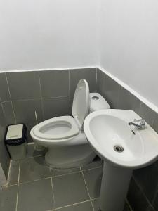 a bathroom with a toilet and a sink at As Thetic Transient in San Pablo +18 photos
