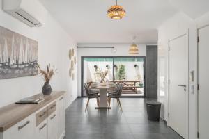 a kitchen and dining room with a table and chairs at Spacious house in Olhao in Quelfes