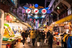 a crowd of people walking through a market at night at SUZUNONE The only private lodging in Tokyo 2 min walk natural hot springs near BIG super market ASAKUSA AKIHABARA SKYTREE nearby Japanese TATAMI style in Tokyo