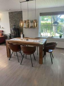 SkambyCozy Holiday Home On North Funen的配有木桌椅的餐厅
