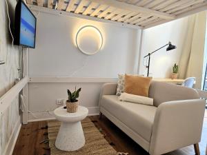 a living room with a couch and a tv at Estrela Charming Rooms 2 by HOST-POINT in Lisbon