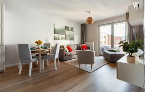 a living room with a couch and a table and chairs at Żurawie 231 in Gdańsk +24 photos