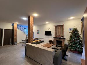 a living room with a christmas tree and a fireplace at Cottage Mountain Dew in Bakuriani in Bakuriani