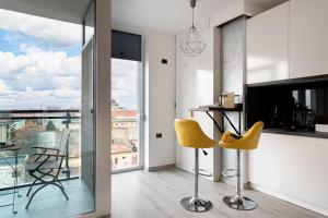 a living room with a table and yellow chairs at Elegant Urban Retreat - City Center in Arad
