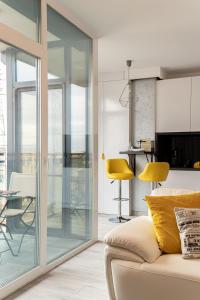 a living room with glass doors and a couch at Elegant Urban Retreat - City Center in Arad