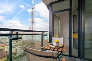a balcony with a table with a cake on it at Elegant Urban Retreat - City Center in Arad