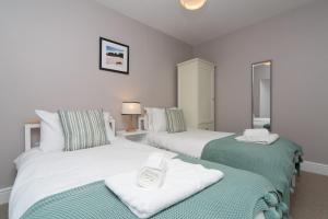 Ένα ή περισσότερα κρεβάτια σε δωμάτιο στο Modernised home 5 minutes from Newborough Beach - Pas the Keys