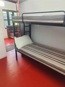 a bunk bed with a pillow sitting on top of it at Cuba beach villa in Alleppey