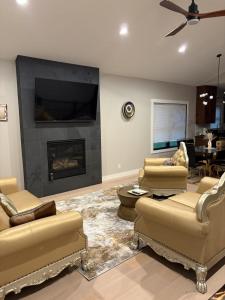 a living room with two couches and a fireplace at Custom Luxury Rambler in Highland Hills in Rochester