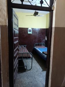 Ένα ή περισσότερα κρεβάτια σε δωμάτιο στο Sundar lodge