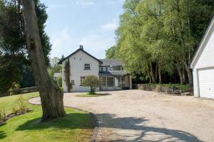 a large white house with a large driveway at Strathendrick House Magnificent property with Garden in Drymen