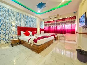 a bedroom with a large bed with red accents at Hotel Relax Residency in Mumbai