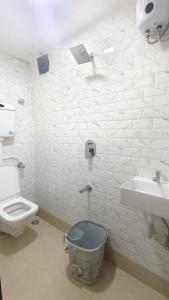 a bathroom with a toilet and a sink at Hotel Relax Residency in Mumbai