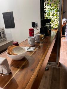 a wooden table with a bowl of food on it at Las cabañas in Tulum