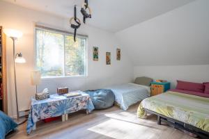 彻特西Cozy Riverside Chalet SPA Fireplace Nature Escape的一间卧室，有两张床、一张桌子和一扇窗户