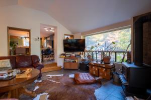 彻特西Cozy Riverside Chalet SPA Fireplace Nature Escape的带沙发和大窗户的客厅