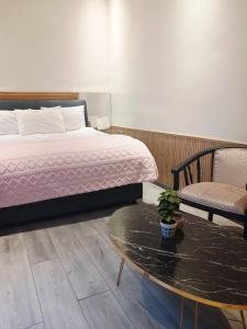 a bedroom with a bed and a table and a chair at Riad Sevilla in Rabat +21 photos