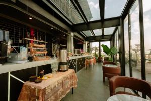 a restaurant with two tables and chairs and windows at X-Digital HOTEL in Bắc Ninh