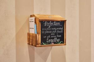 a wooden box with a chalkboard on a wall at Host & Stay - The Shipshape in Seahouses